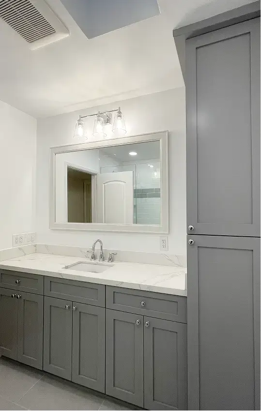 bathroom vanity with gray paneled cabinets