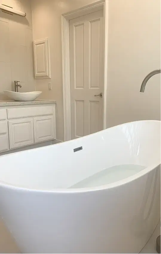 bathroom with a freestanding white soaking tub