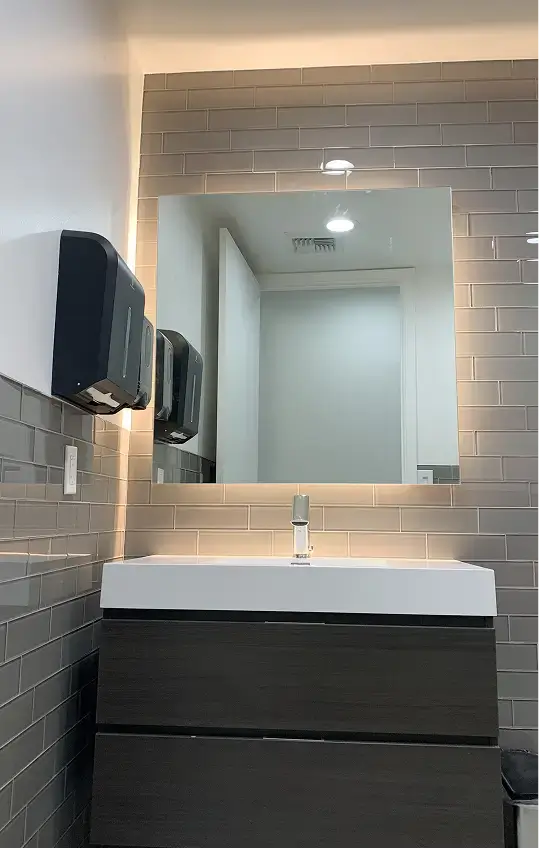 restroom vanity with a white sink